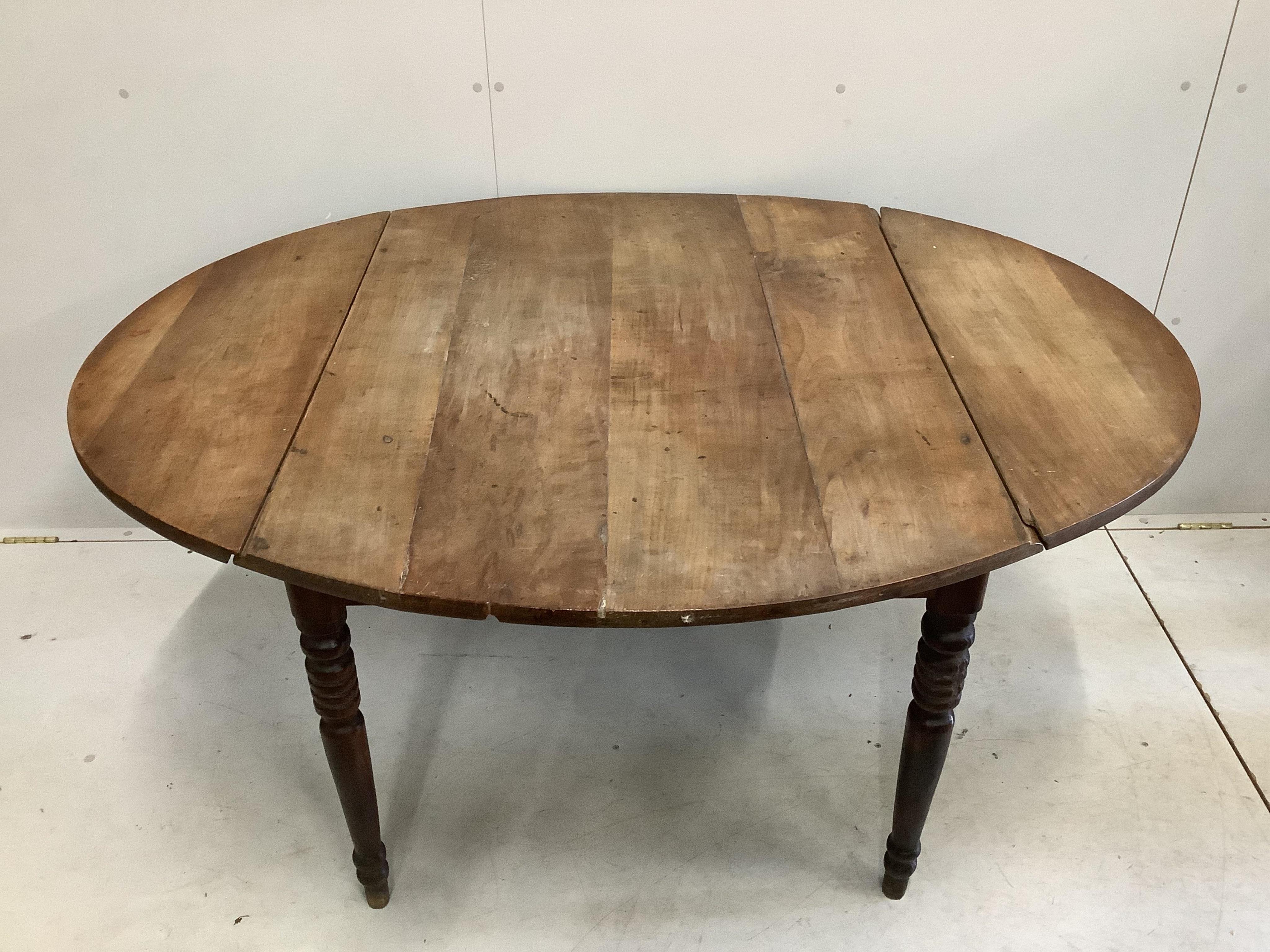 A large 19th century French cherry drop leaf dining table, width 112cm, 142cm extended, height 73cm. Condition - poor to fair